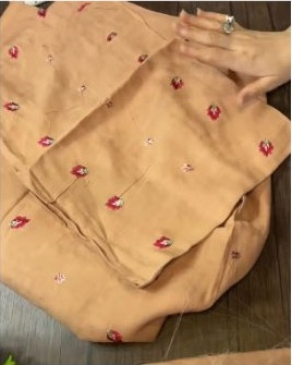 Peach fabric with red buti work