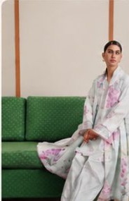 Lilac printed suit on a green sofa